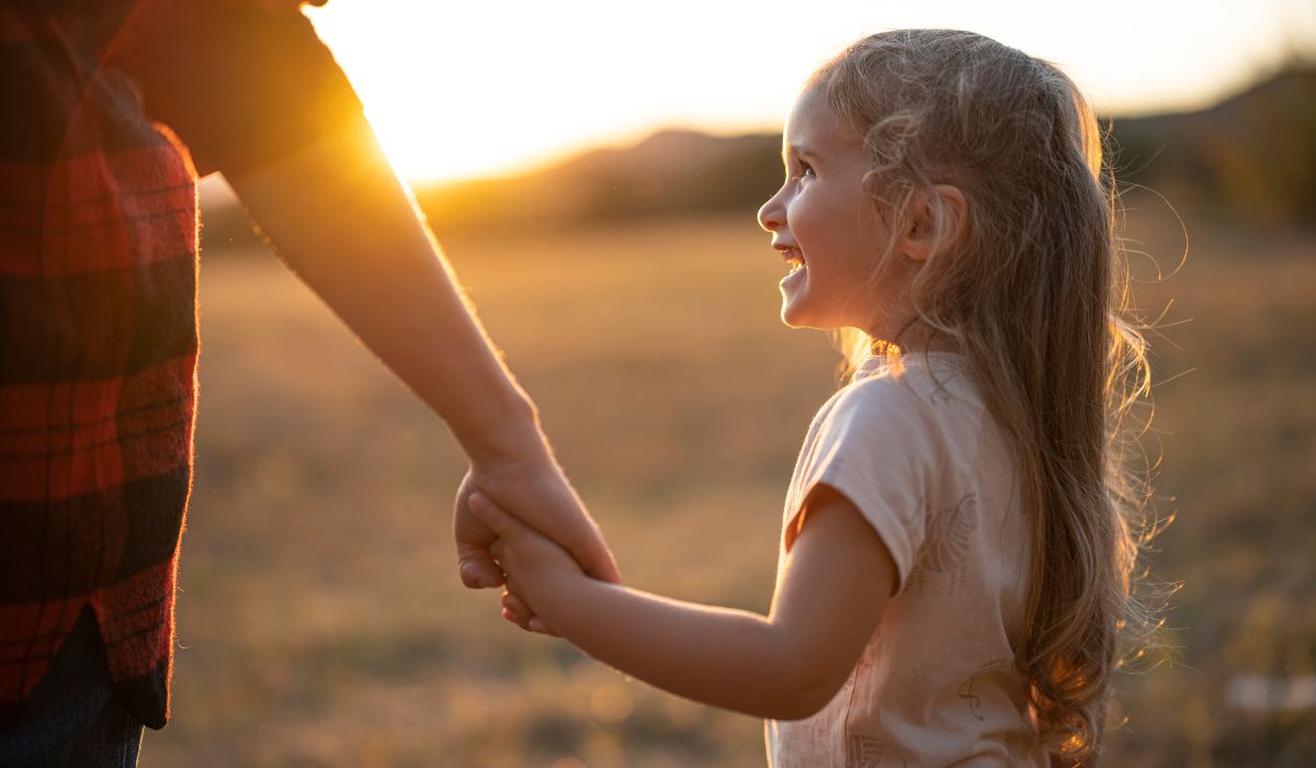 Mother and daughter holding hands