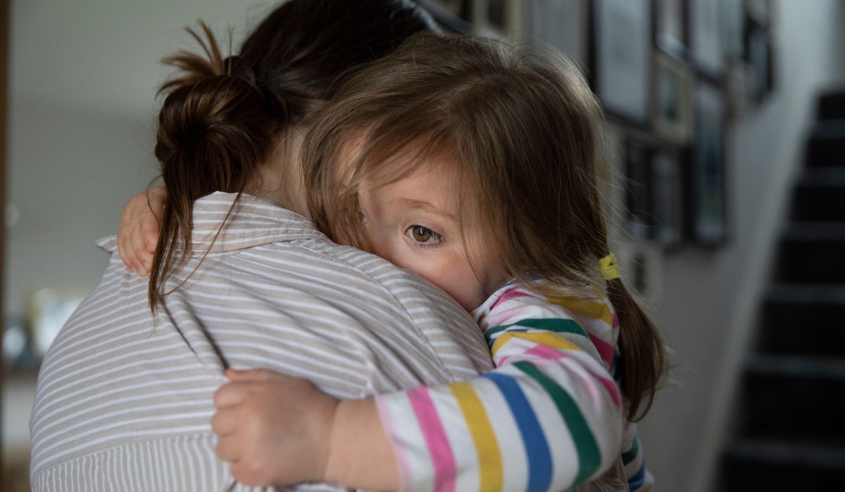 Single mother hugging child