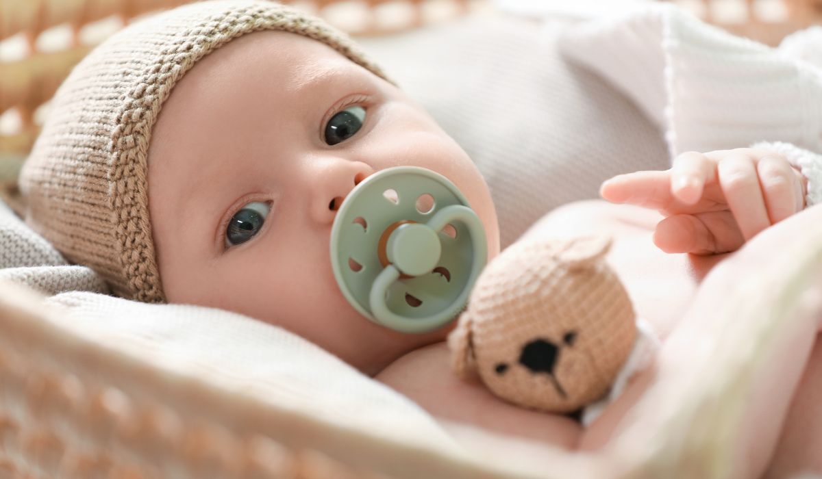 Baby with a green soother