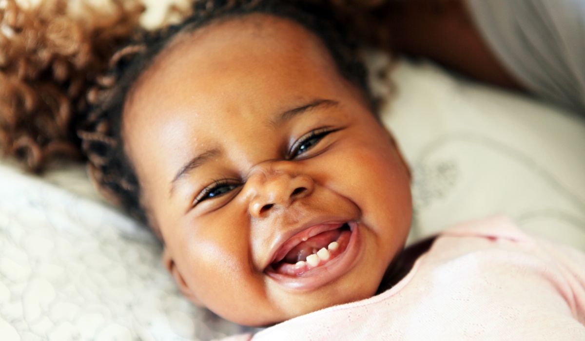 Cute teething baby smiling