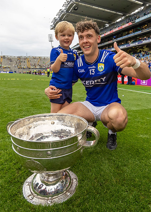 David Clifford celebrates with his son Ogie and the Sam Maguire cup