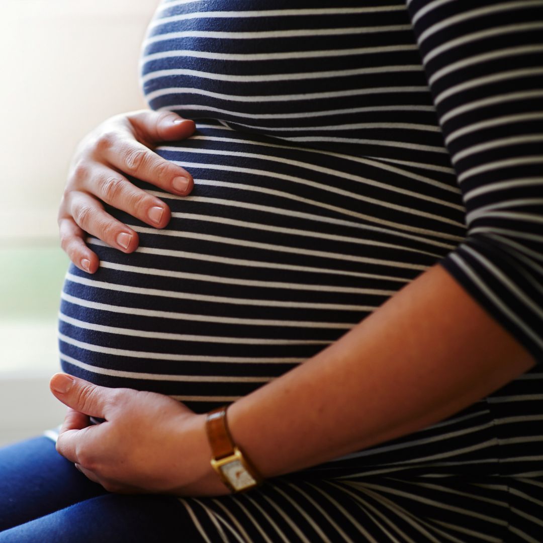 Pregnant woman holding her stomach
