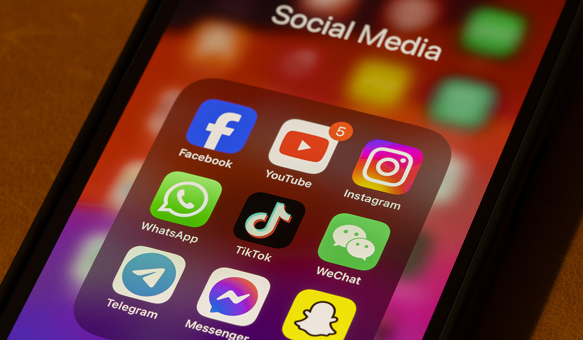 Some of the most popular social media apps by number of monthly active users, including Facebook, YouTube, Instagram, WhatsApp, TikTok, WeChat, Telegram, Messenger, and Snapchat, are seen on an iPhone.