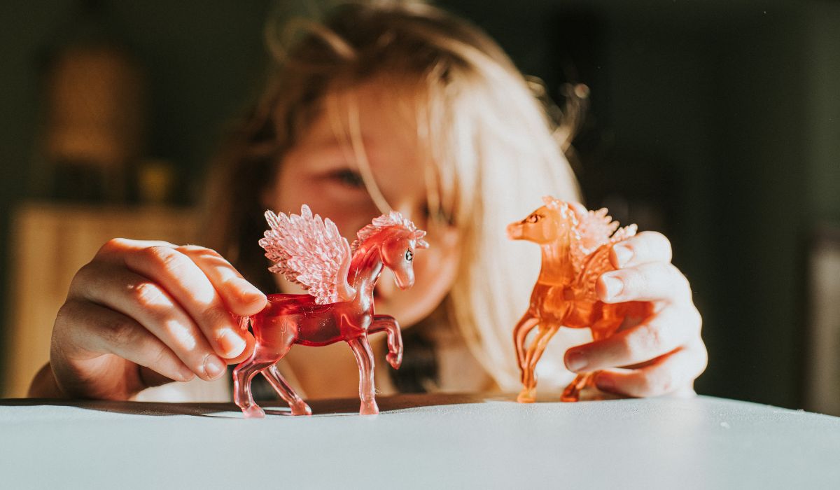 Girl playing with unicorns