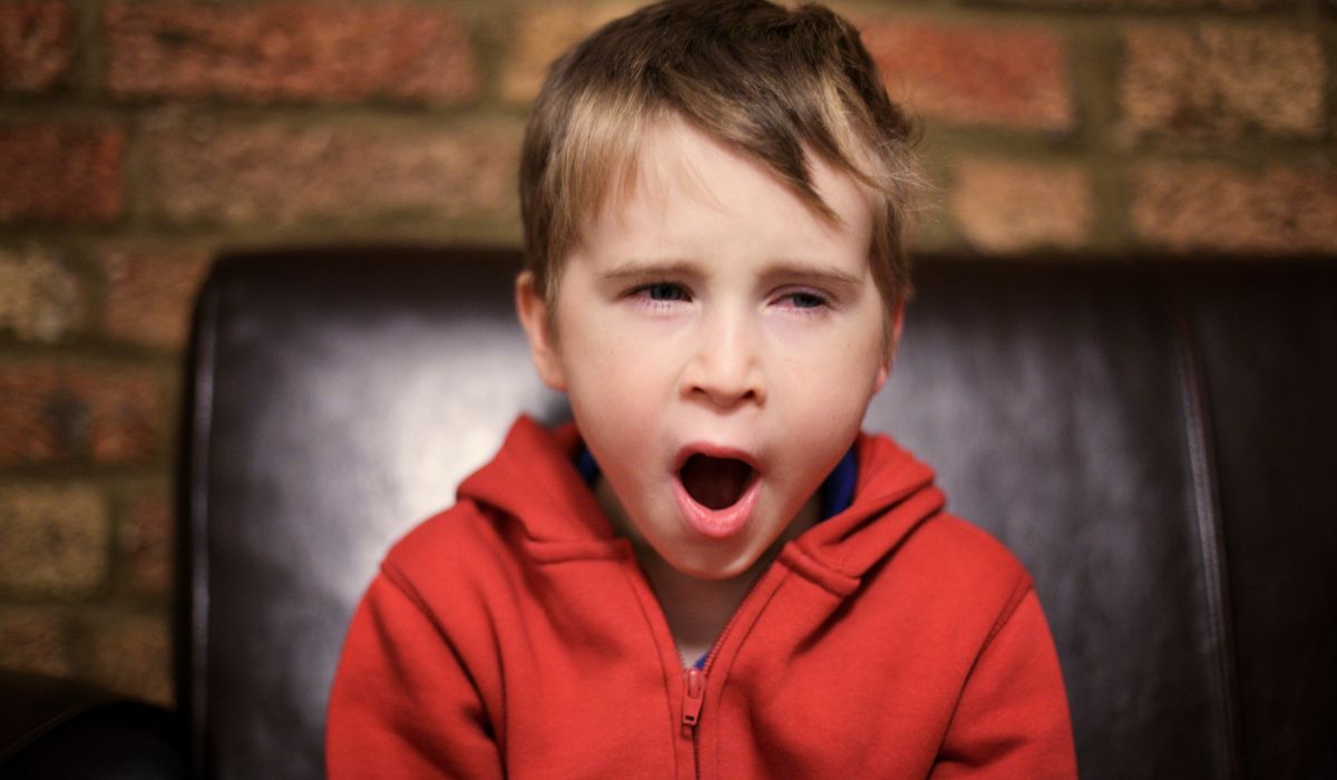 Tired child yawning