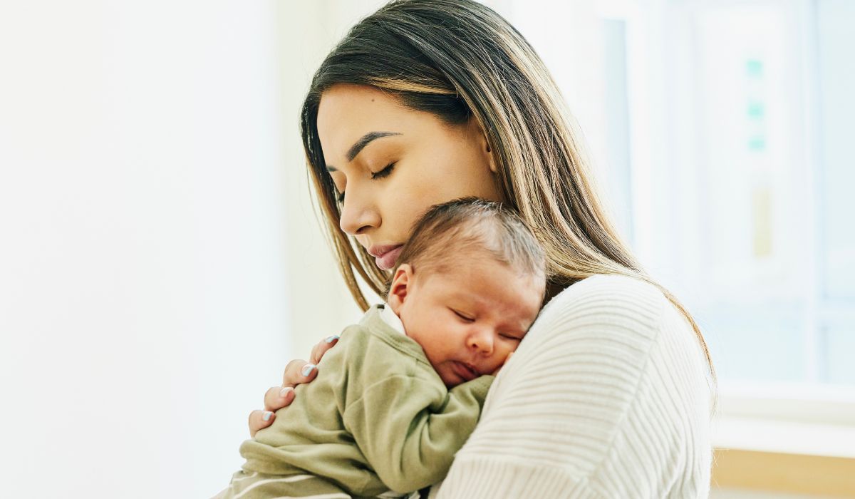Mum holding a baby on her shoulder