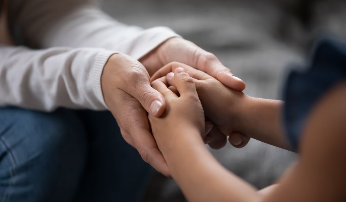 Parents holding child's hands