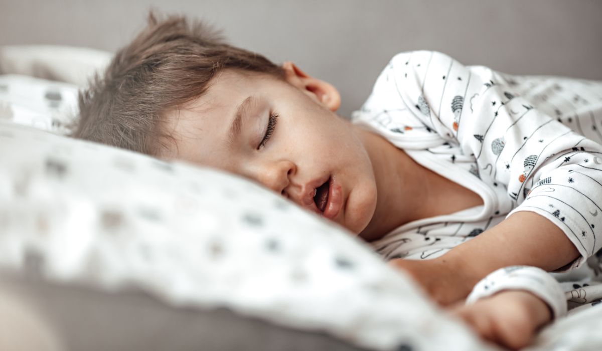Toddler asleep in bed