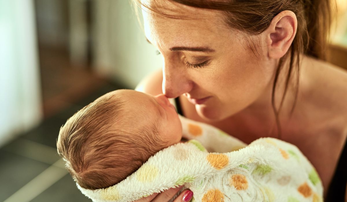 Woman kissing her baby