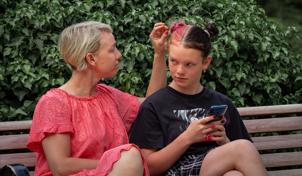 Mother stroking daughter's face