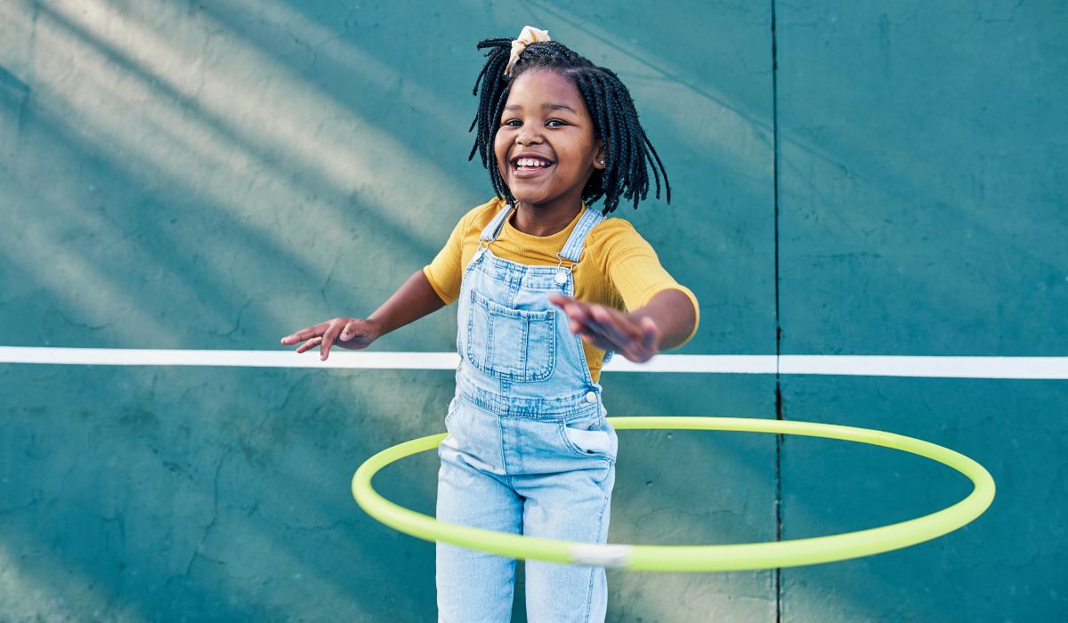 Little girl using a hula hoop