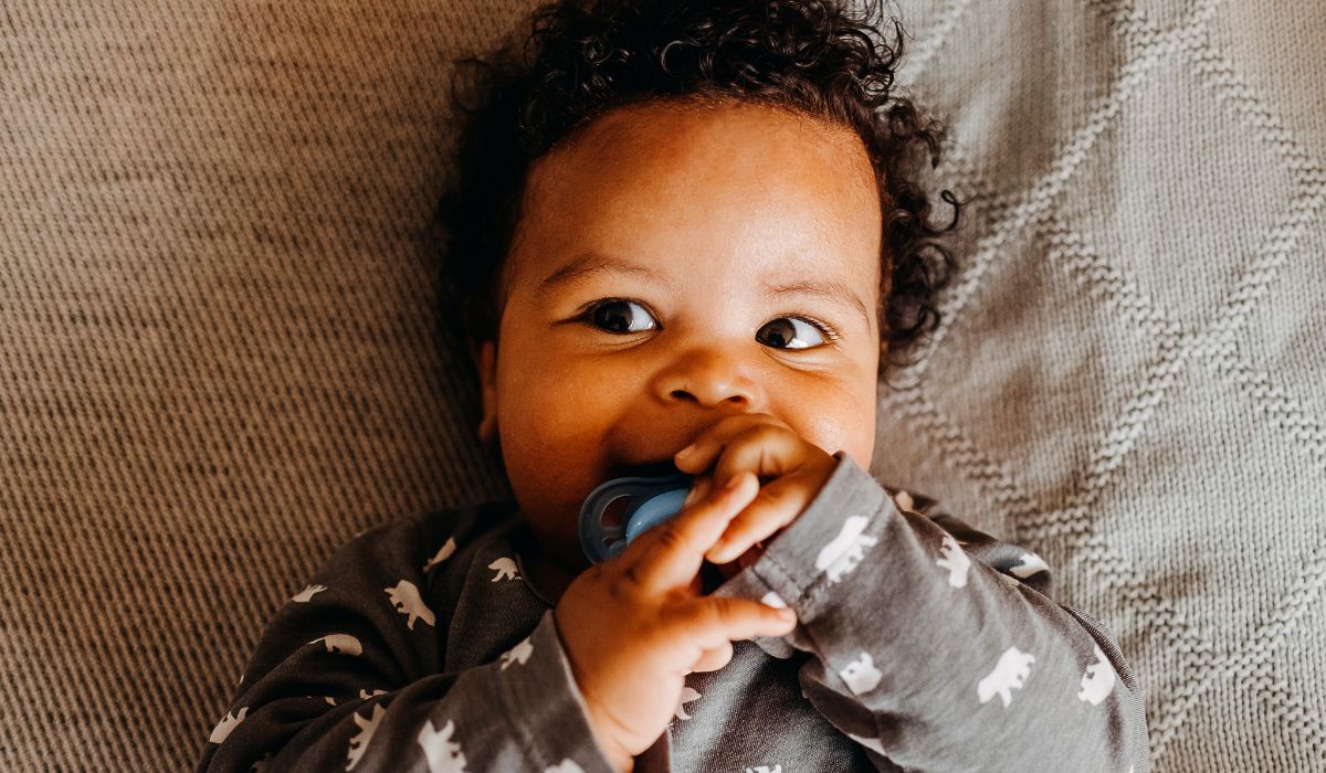 Baby with soother in his mouth