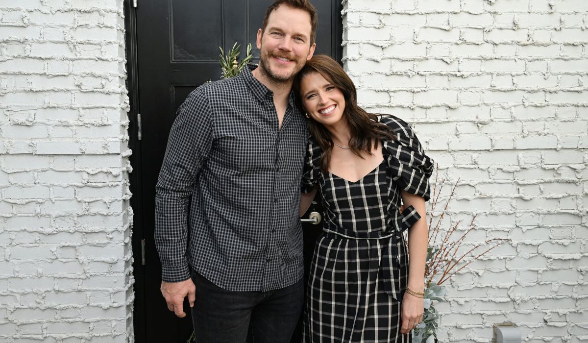 Katherine Schwarzenegger and Chris Pratt standing in front of a brick wall