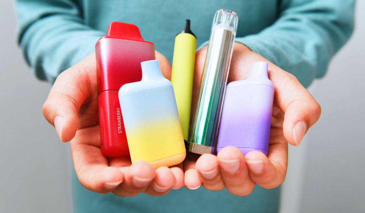 Person holding vapes