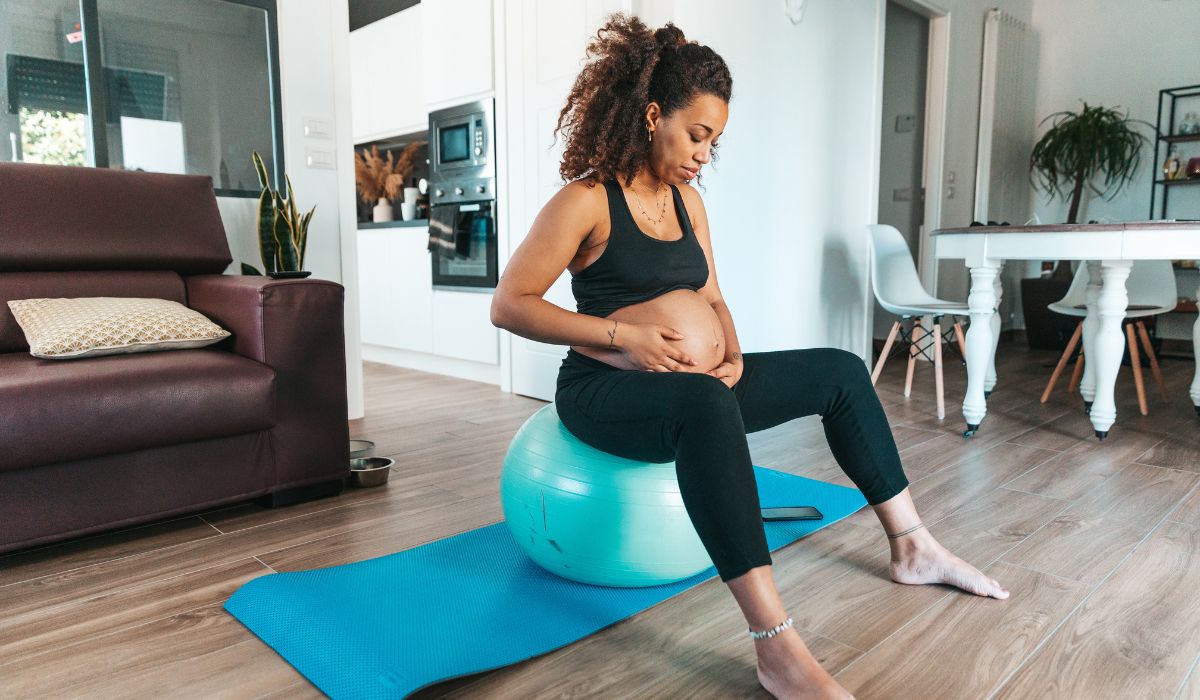 Woman using birthing ball