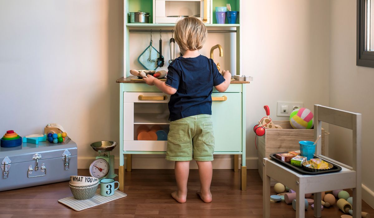 Child at a play kitchen