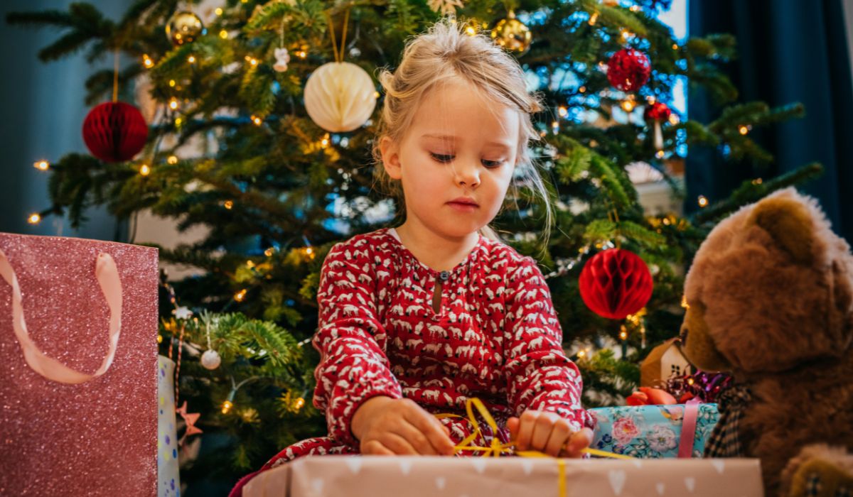 Girl opening present on Christmas morning