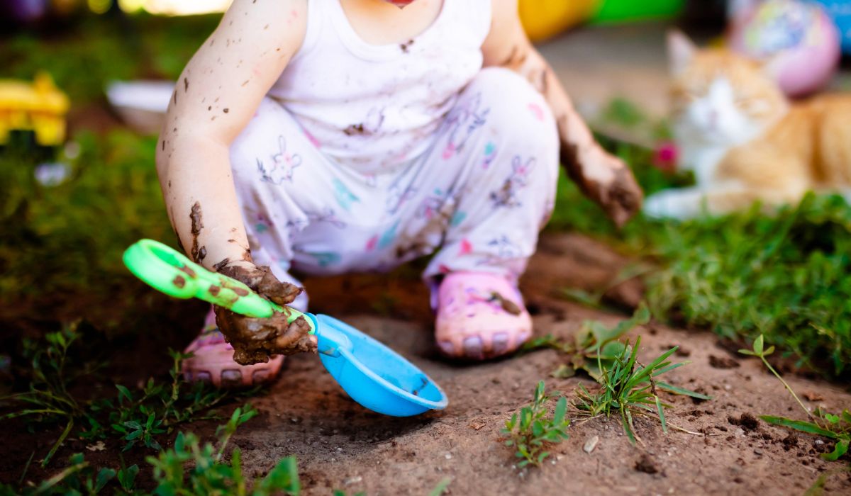 Baby playing in mud