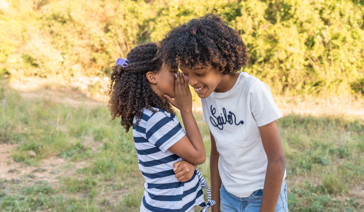 Children whispering to each other