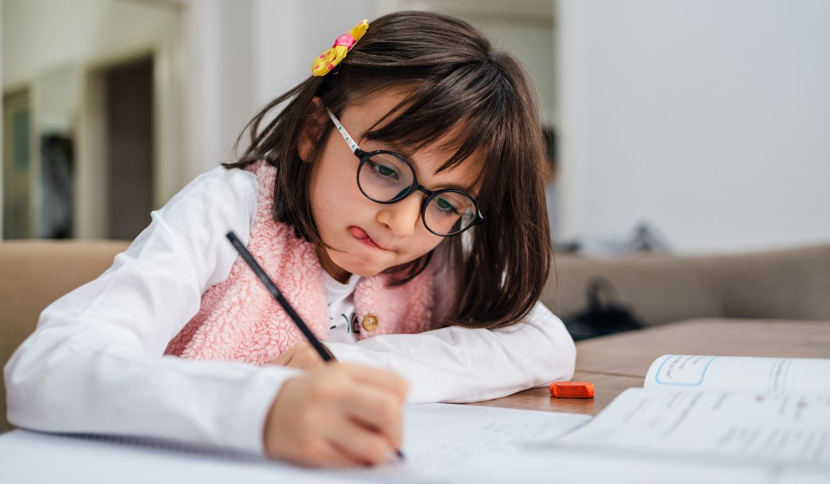 Little girl writing in primary school