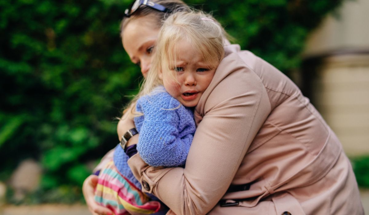 Mother hugging her crying daughter