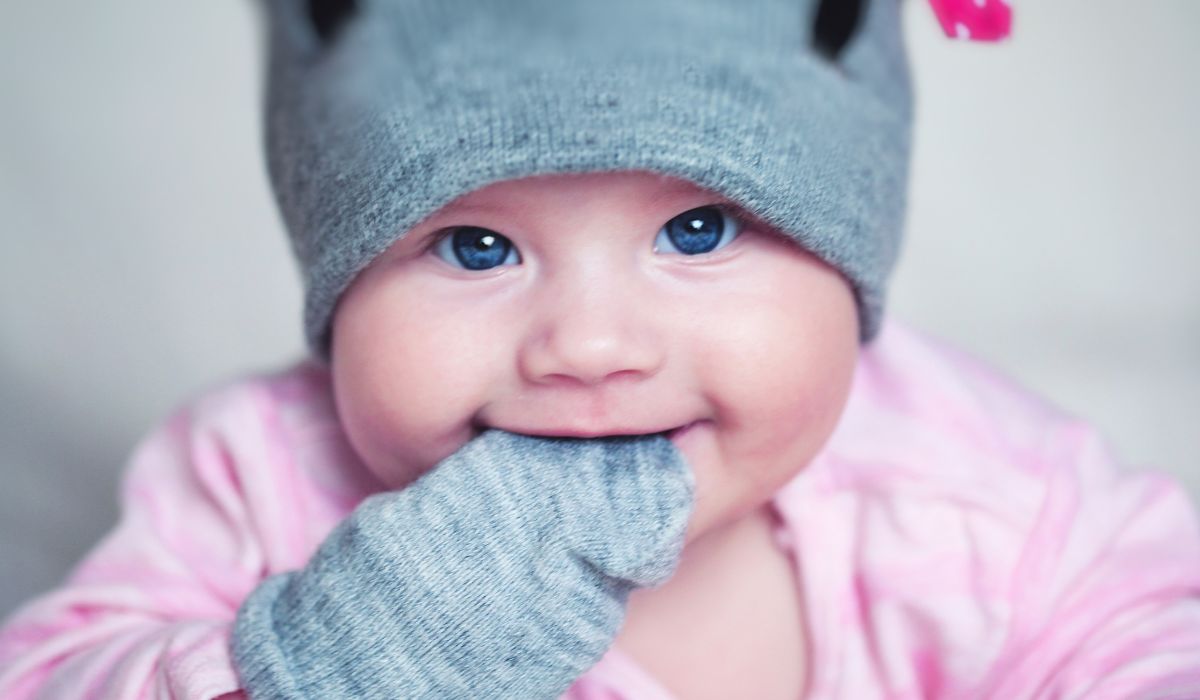 Baby wearing mittens