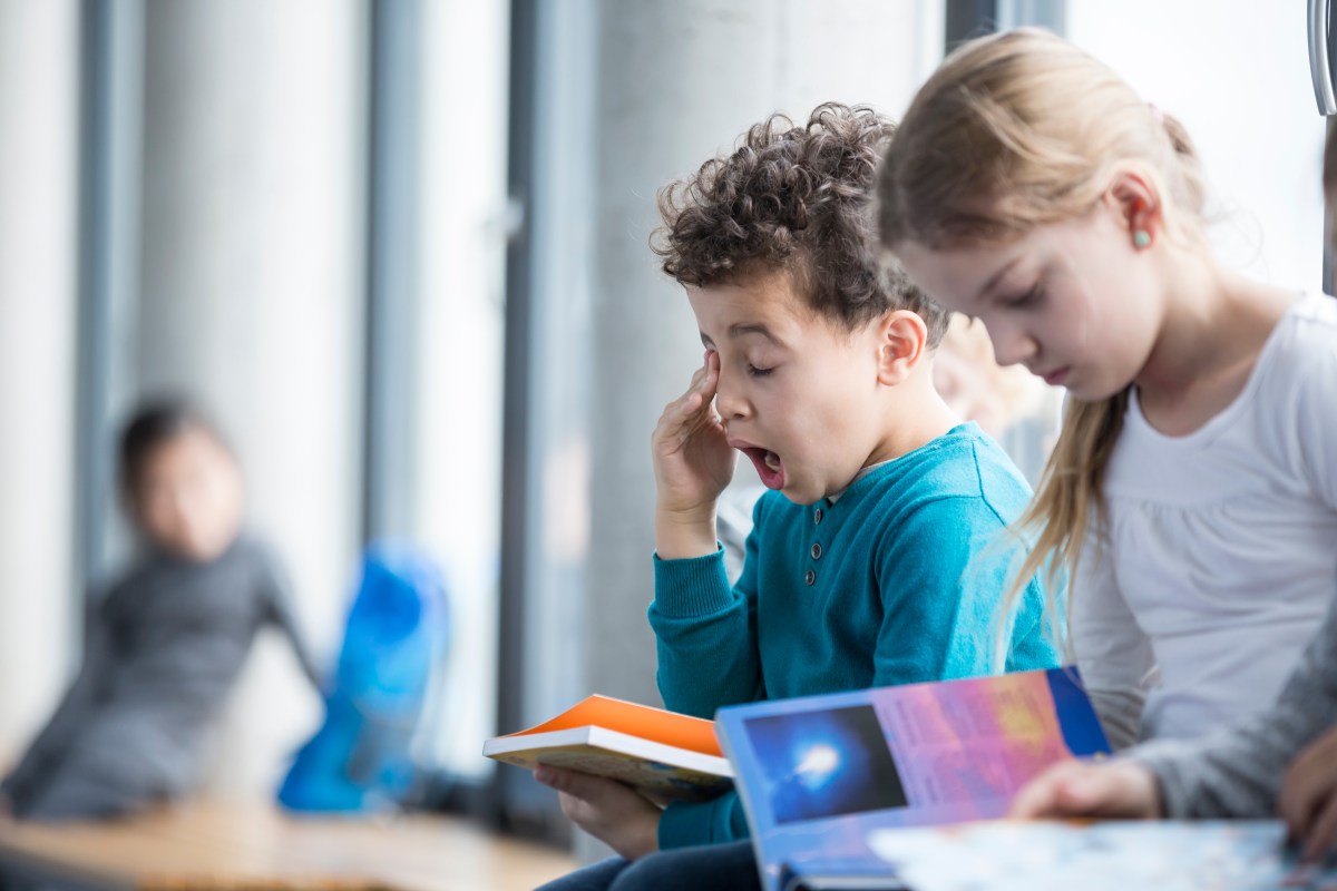 Tired child in school