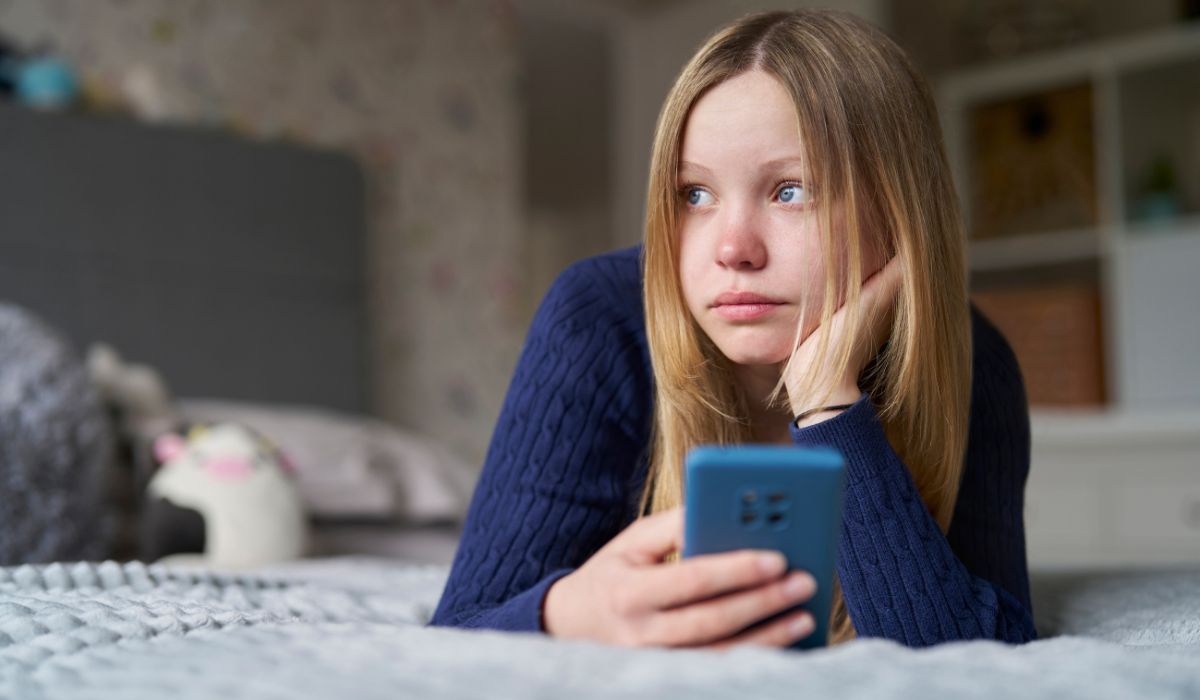 child being bullied on her phone