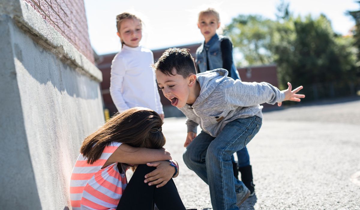 Girl being bullied by young children at school
