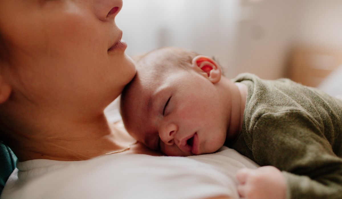 Baby asleep on mum