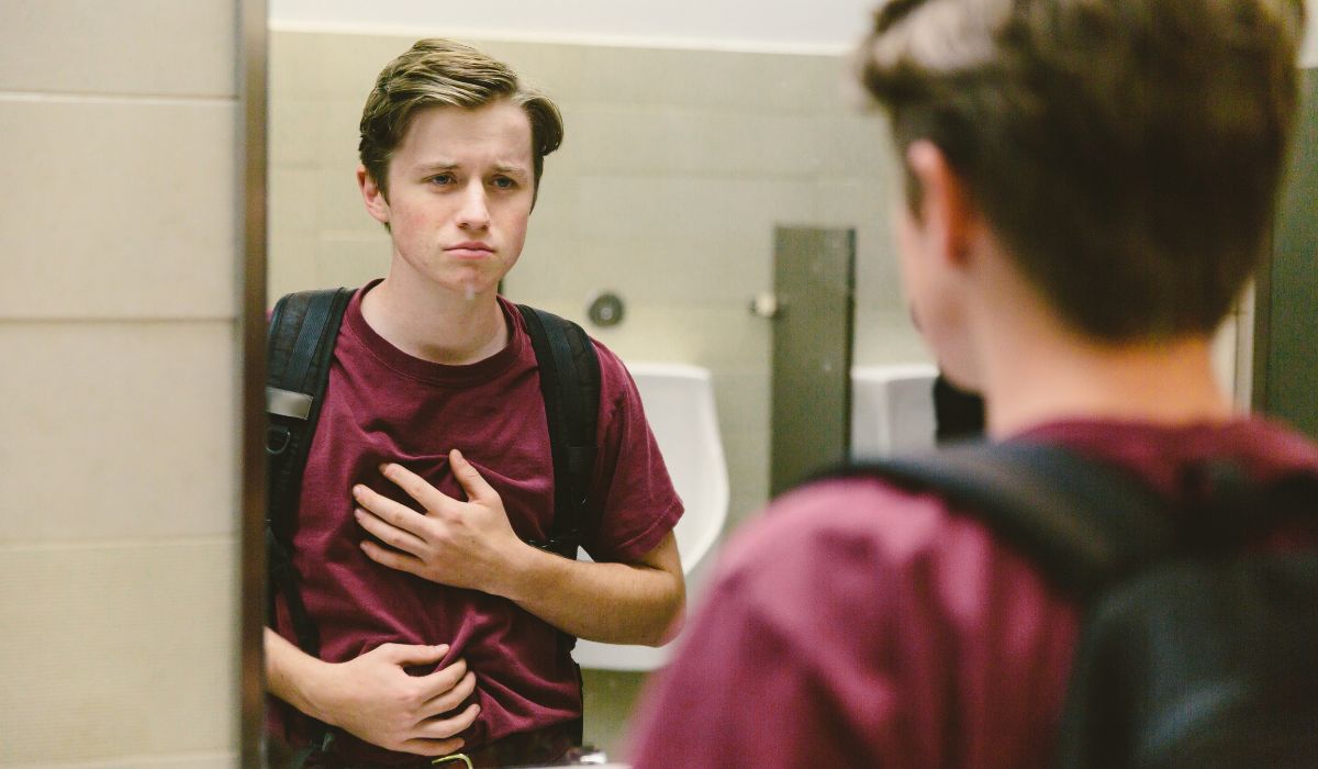Teenage boy looking in the mirror