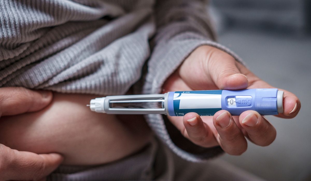 Person injecting weight loss medication