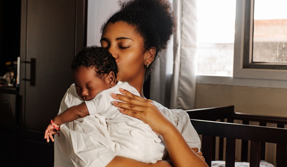 Mother kissing baby