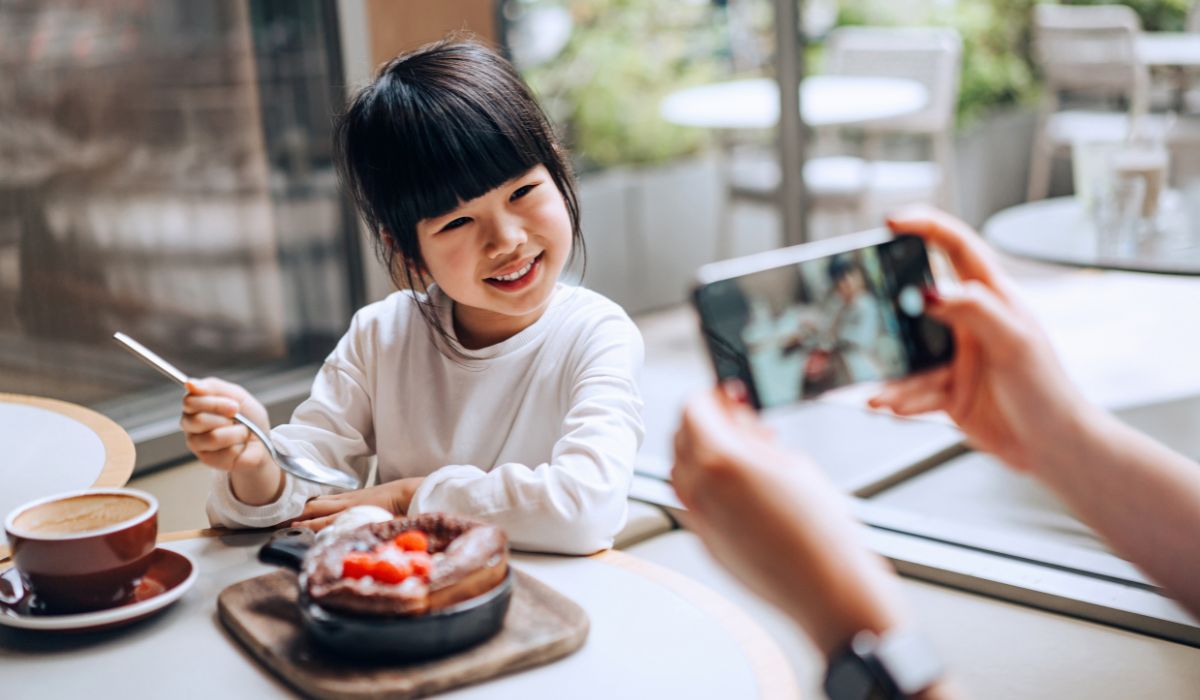 Parent taking photo of daughter