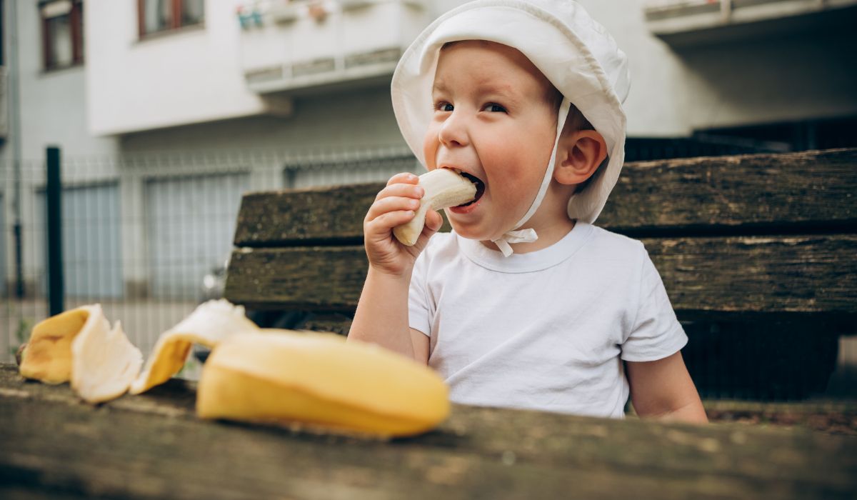 Toddler eating banana