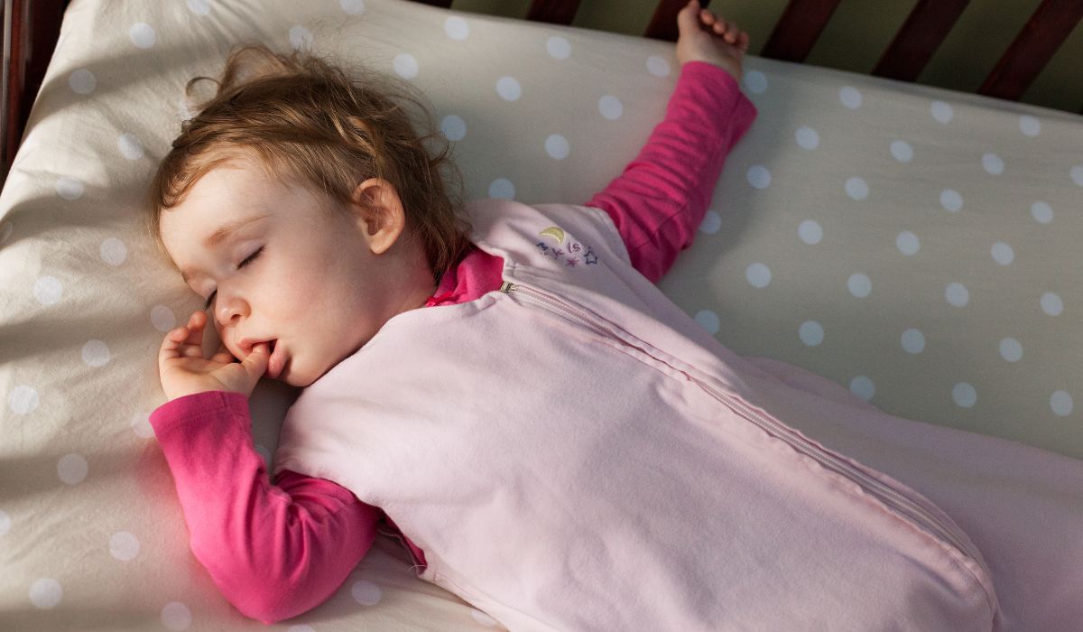 Baby sleeping in cot