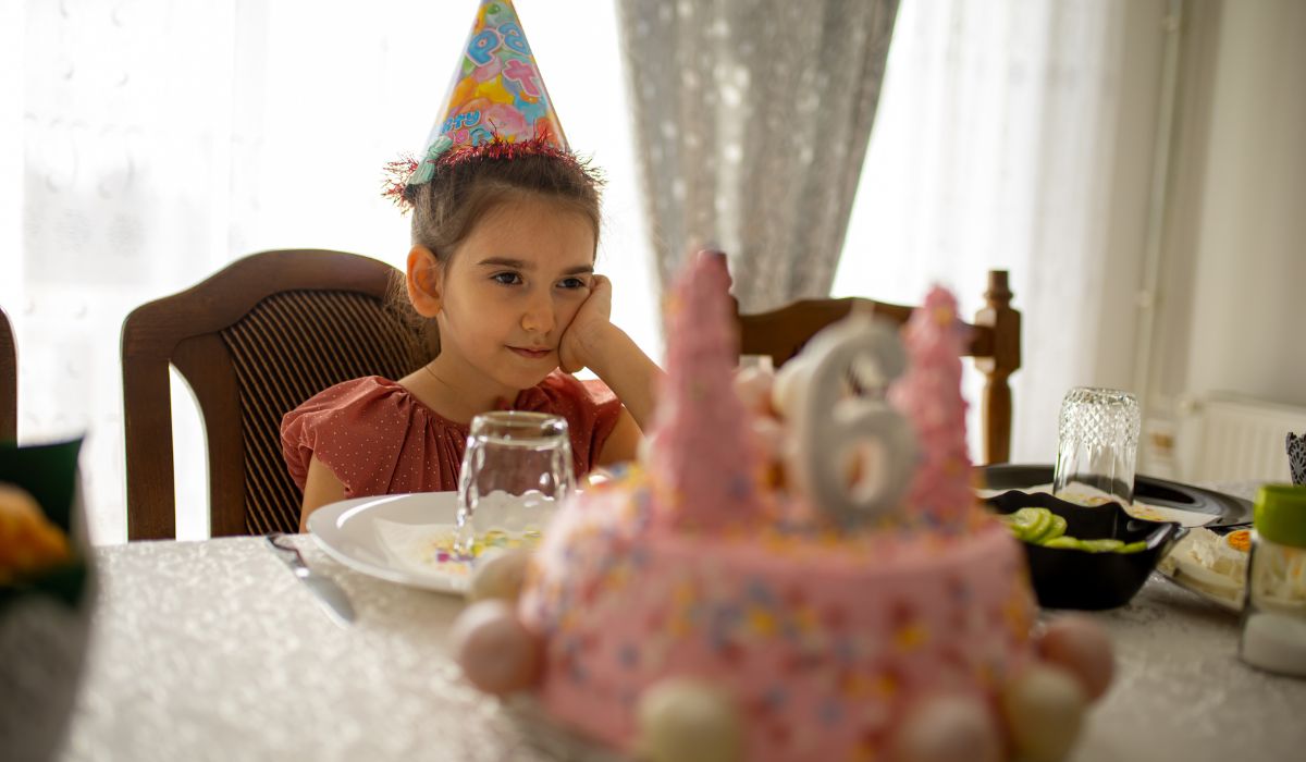 Sad child at birthday party