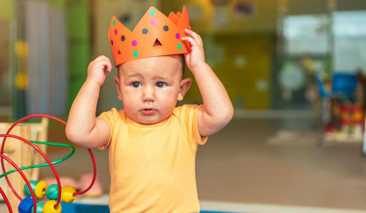 Baby boy wearing a paper crown