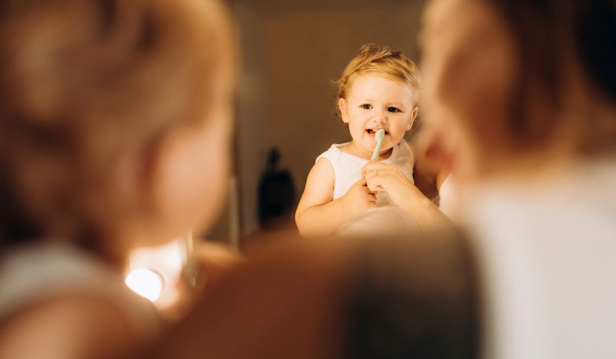 Mother brushing toddler's teeth