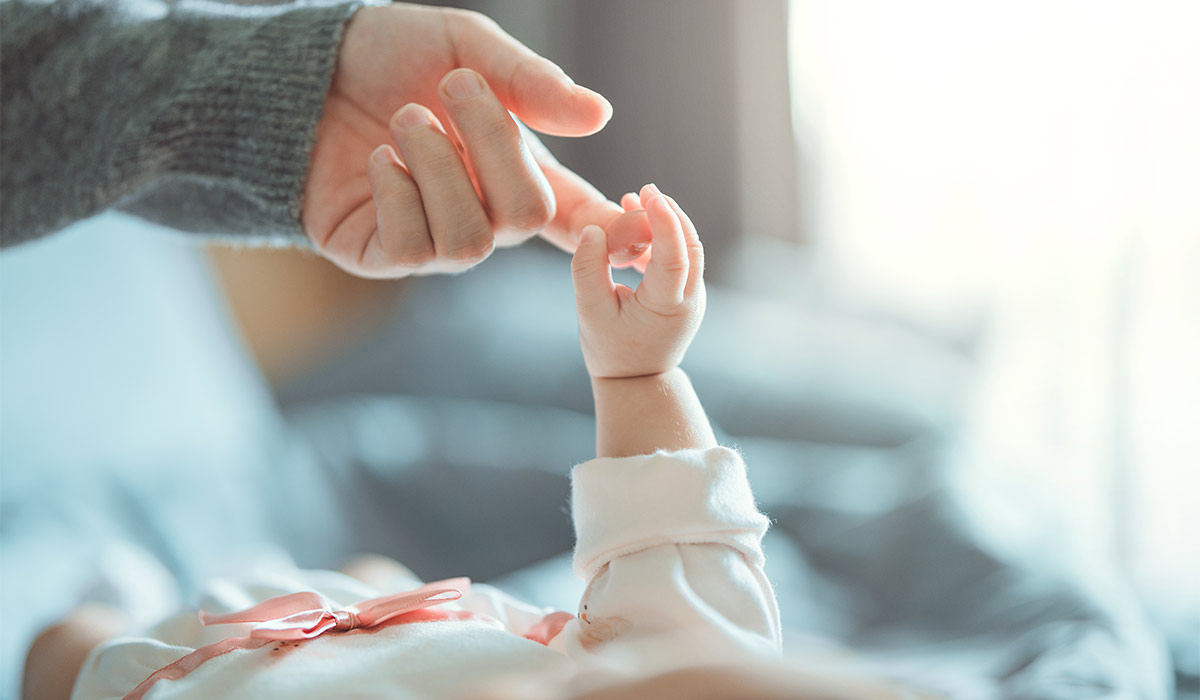 Newborn baby girl holding parent’s finger – symbol of love, trust, and bonding between mother, father and child.; Shutterstock ID 2609913151; purchase_order: -; job: -; client: -; other: