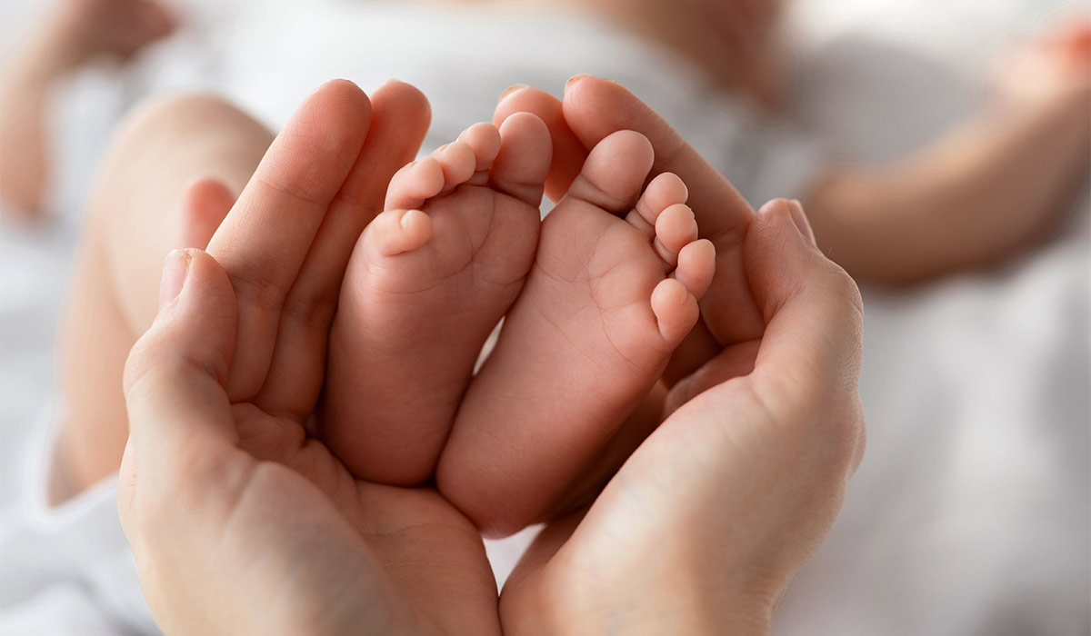 Closeup Shot Of Tiny Newborn Baby Feet In Mother's Hands; Shutterstock ID 2664231115; purchase_order: -; job: -; client: -; other:
