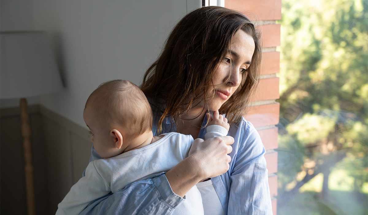 Stressed new mother holding baby experiencing postpartum depression; Shutterstock ID 2710571129; purchase_order: -; job: -; client: -; other: