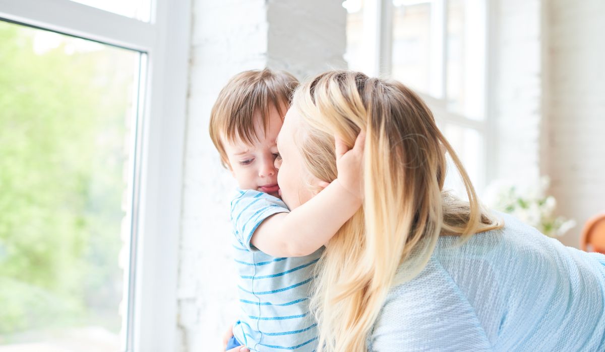 Mother kissing toddler son