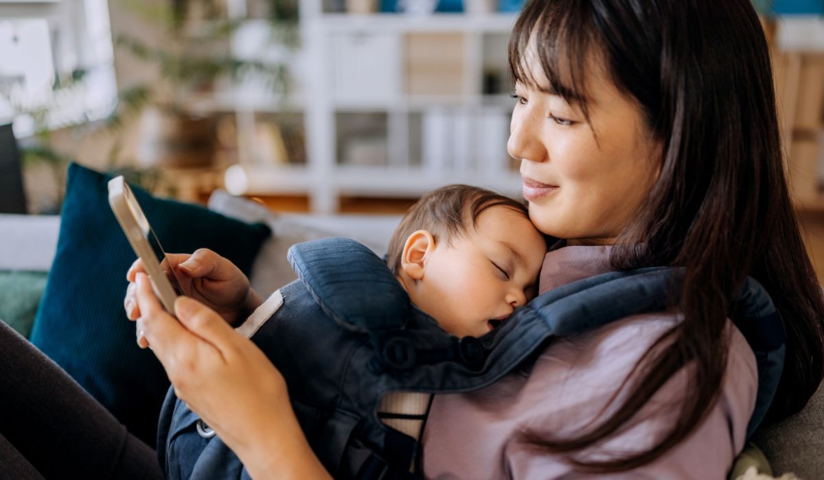 Mother holding baby in carrier