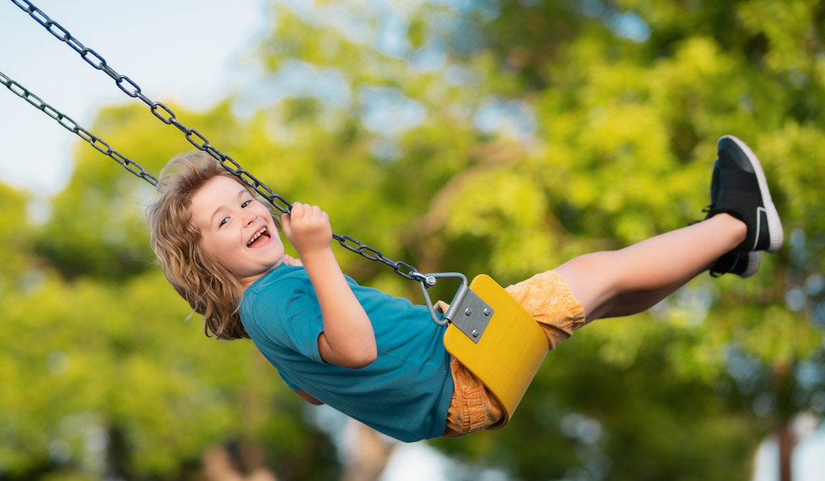 Little kid swinging portrait. Adorable child having fun on a swing on summer day. Happy dream. Dreamy kids face. Daydreamer child portrait close up. Dreams and imagination.; Shutterstock ID 2342227883; purchase_order: -; job: -; client: -; other: