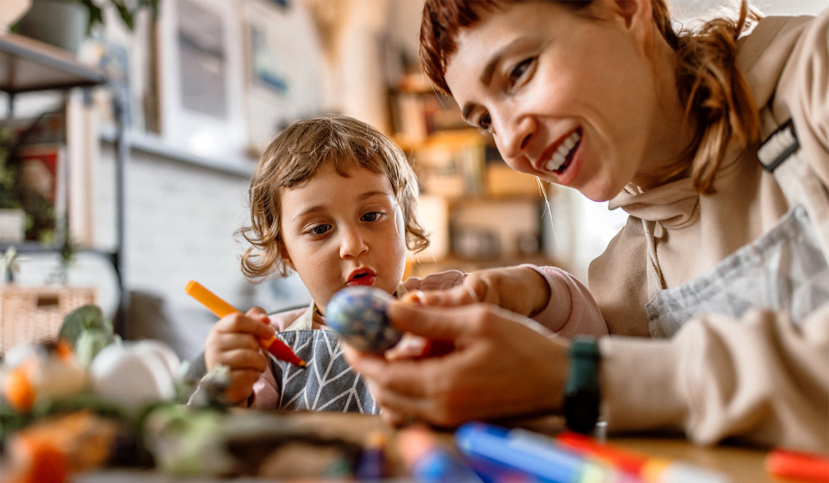Single mother making easter decoration with her toddler daughter. Bonding time.
