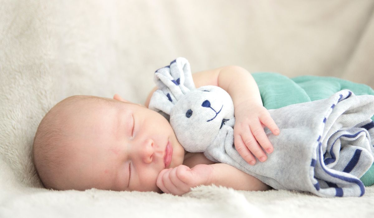 Baby holding comfort blanket