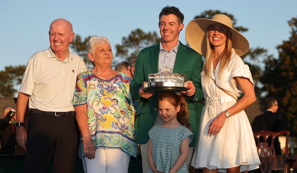 Rory McIlroy (C) of Northern Ireland poses with the Masters trophy during the Green Jacket Ceremony alongside father Gerry (L), mother Rosie (2nd L), wife Erica (2nd R) and daughter Poppy. PIC: Hector Vivas/Getty Images