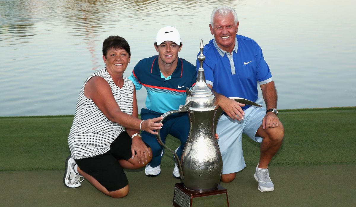 Rory McIlroy of Northern Ireland poses with his parents, Rose and Gerry McIlroy