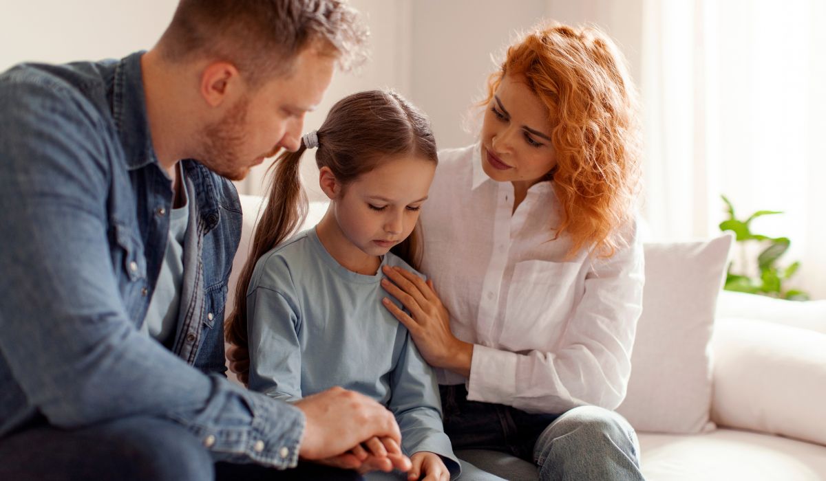 Parents comforting sad child